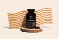 COHALA Wellness Mushroom X supplement bottle on a wood slice in front of a wavy wooden backdrop